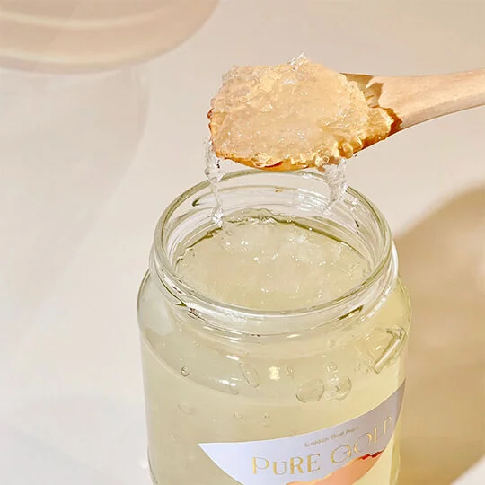 a jar of honey with a metal lid